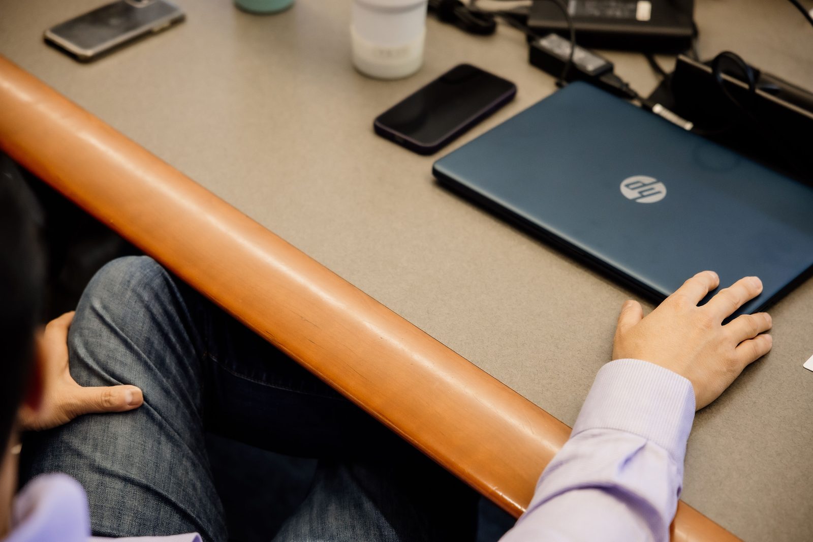 A laptop and notes on a boardroom table during a working session